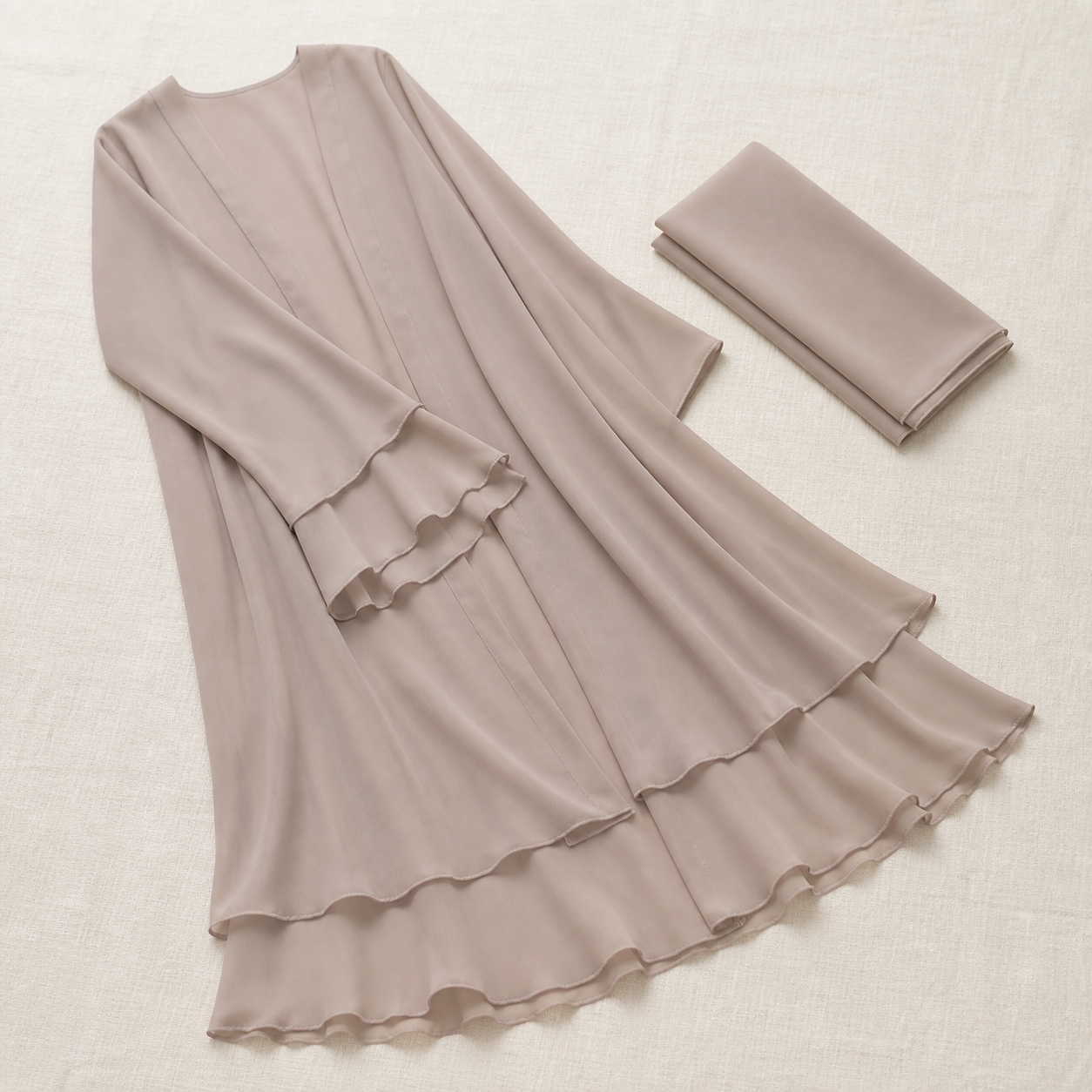 Hana open abaya in taupe folded flat beside its matching chiffon shayla