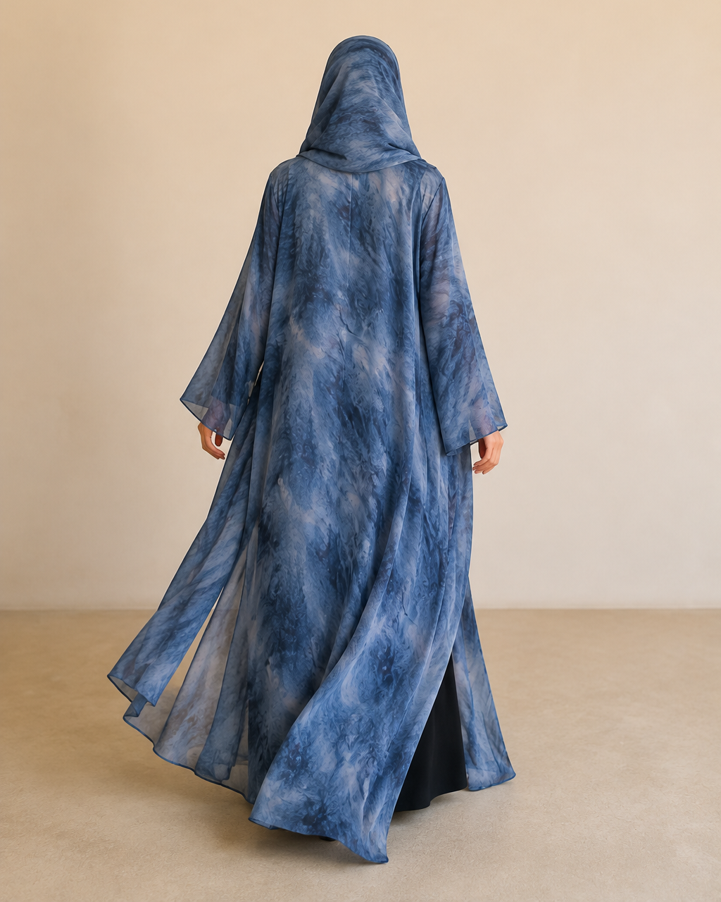 Sama printed abaya in Blue — back view in motion, full length, the print continuing on the shayla