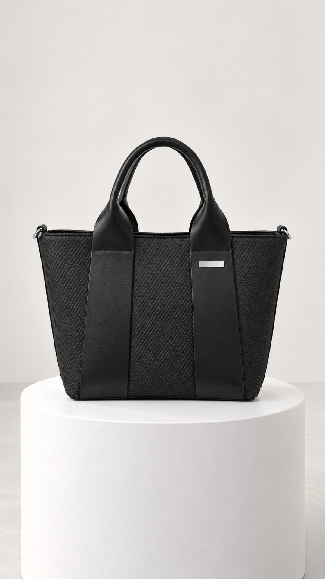 Reem Top-Handle Bag in black, front view