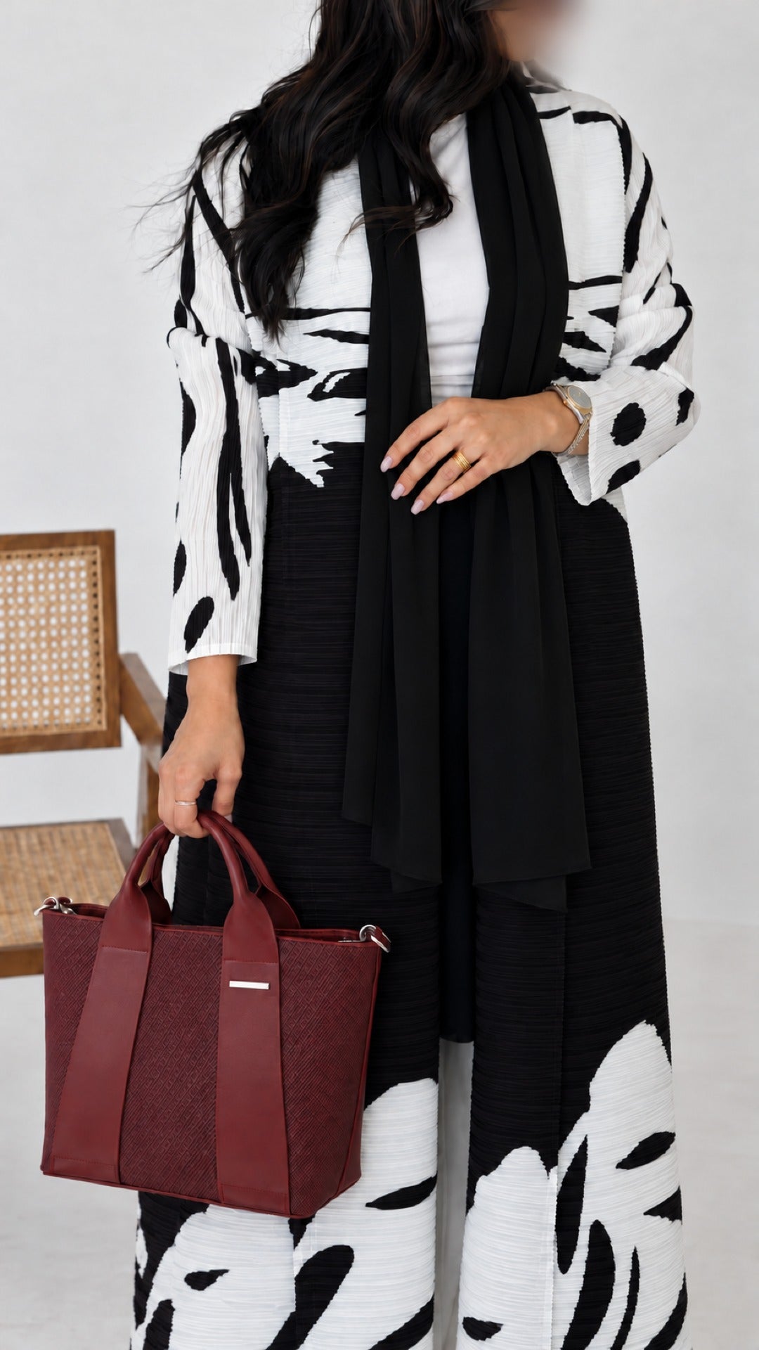Close-up of the Reem Top-Handle Bag in wine held by its top handles