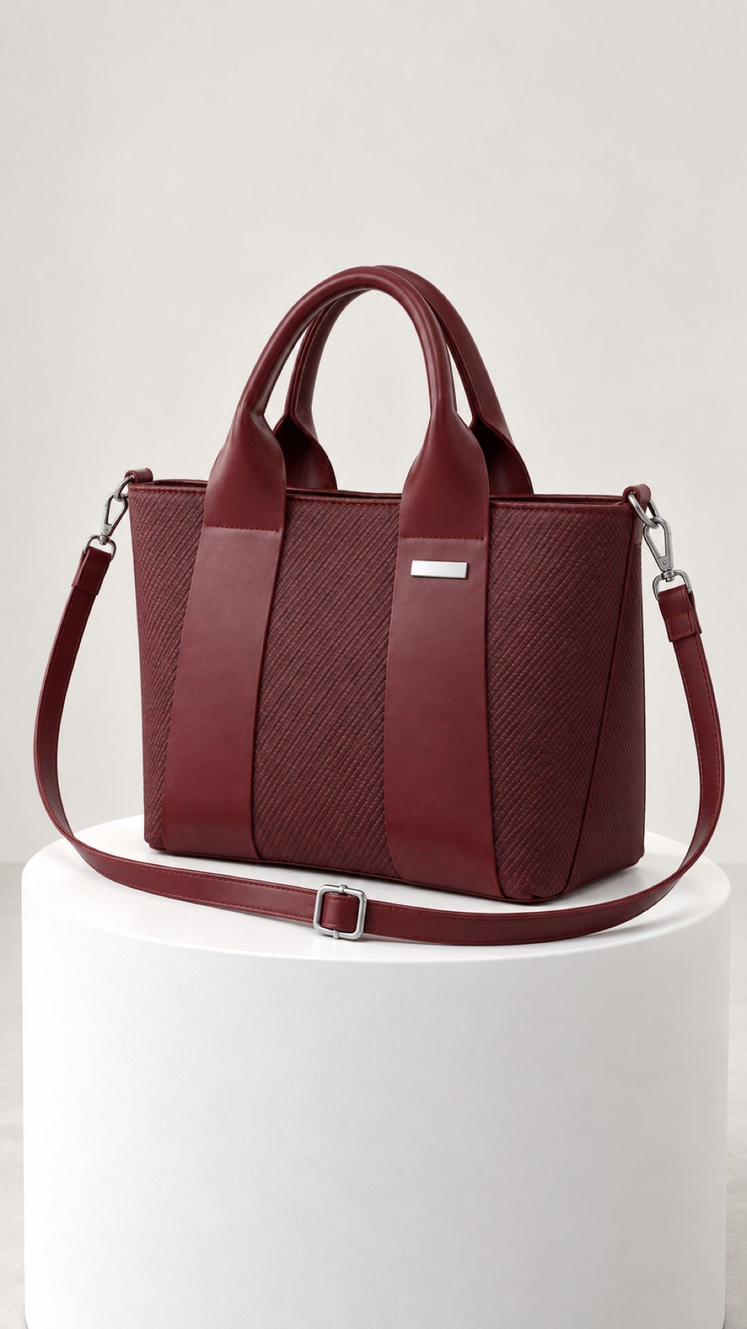 Reem Top-Handle Bag in wine, side view with the detachable shoulder strap